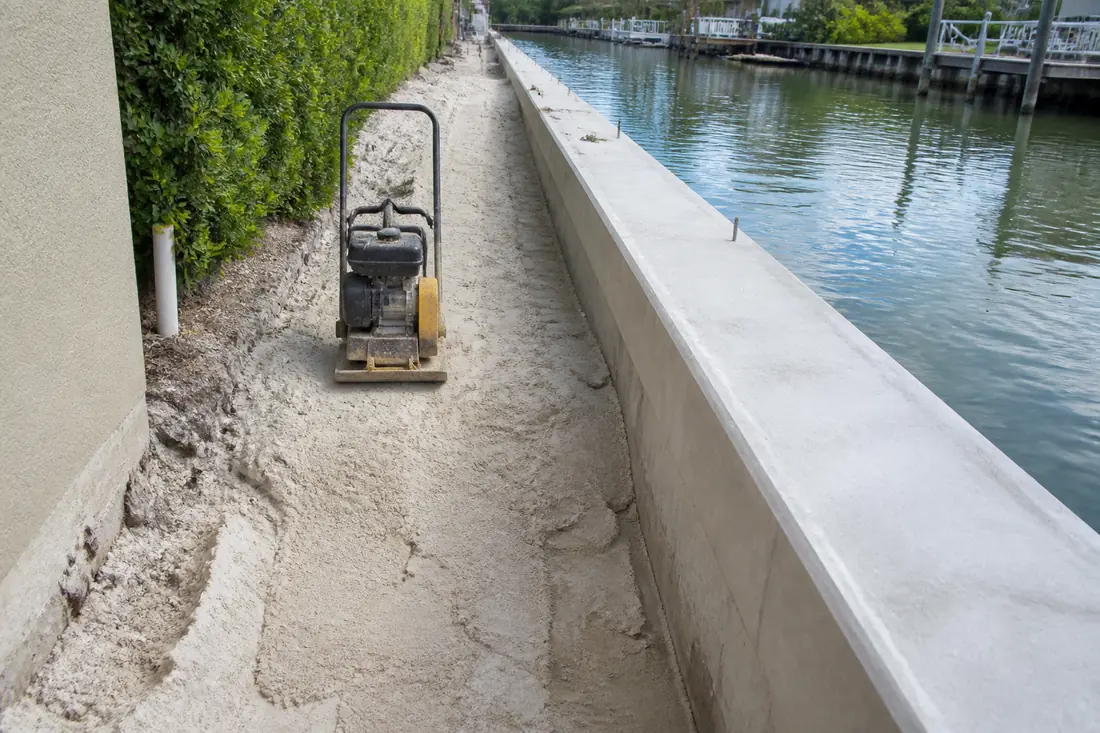 Sand backfill being placed behind a newly built seawall