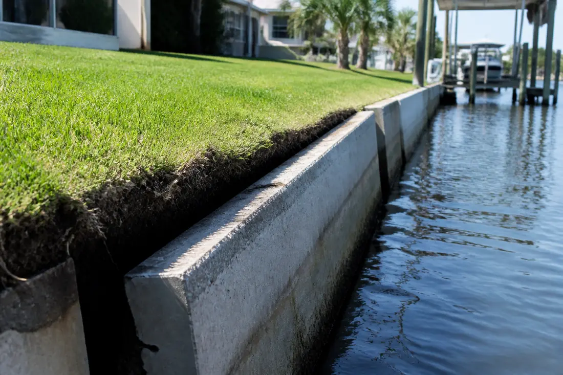 A seawall cap tilted forward towards the water