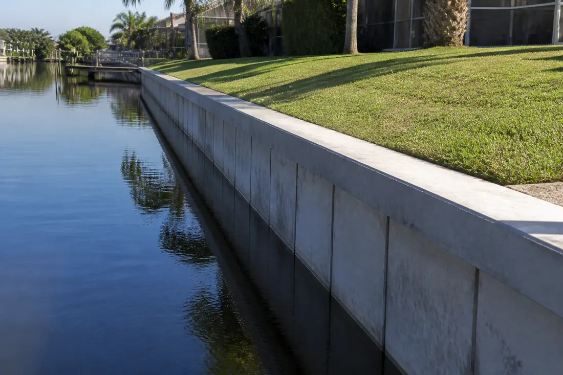 A concrete seawall running along a Charlotte County canal